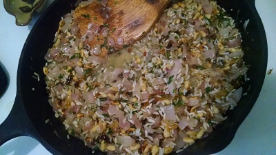 Add chopped yellow raisin, crickets, pine nuts, salt, and rice. Stir to coat rice in oil, cooking about 1-2 min.